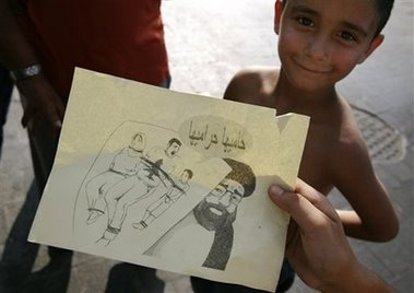 Youths examine Israeli propaganda leaflets dropped on the Lebanese city of Tyre