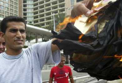 A Lebanese man burns Israeli air dropped leaflets