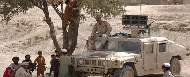 Operation Enduring Freedom: U.S. Army Sergeant sits atop his Humvee equipped with a loudspeaker system.